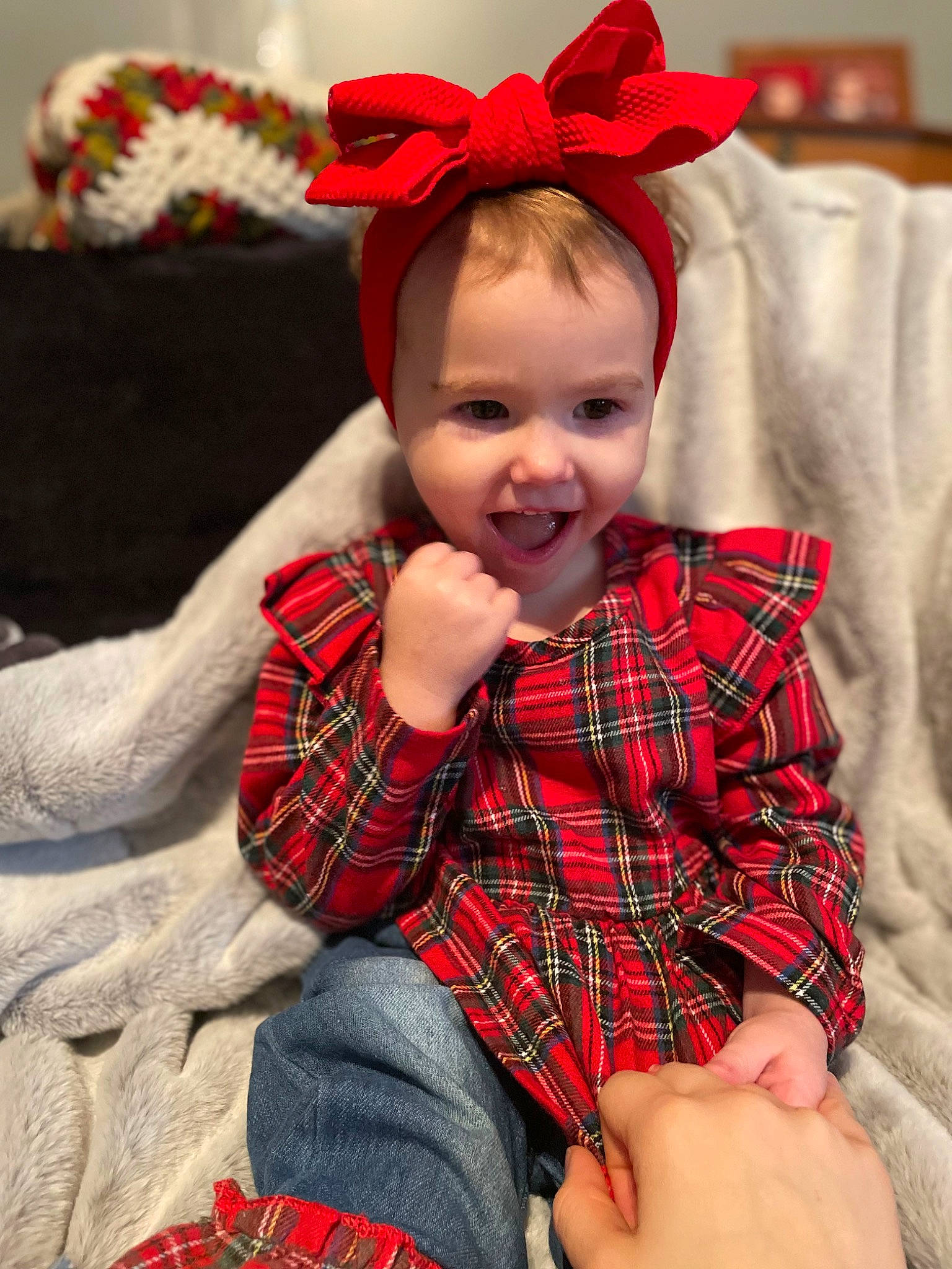 Emma-lee is registered to the contest to win money with this photo: baby, baby_toddler_clothing, christmas, comfort, costume_hat, face, happy, head, holiday, human_body, pattern, person, plaid, red, skin, sleeve, smile, sock, tartan, textile