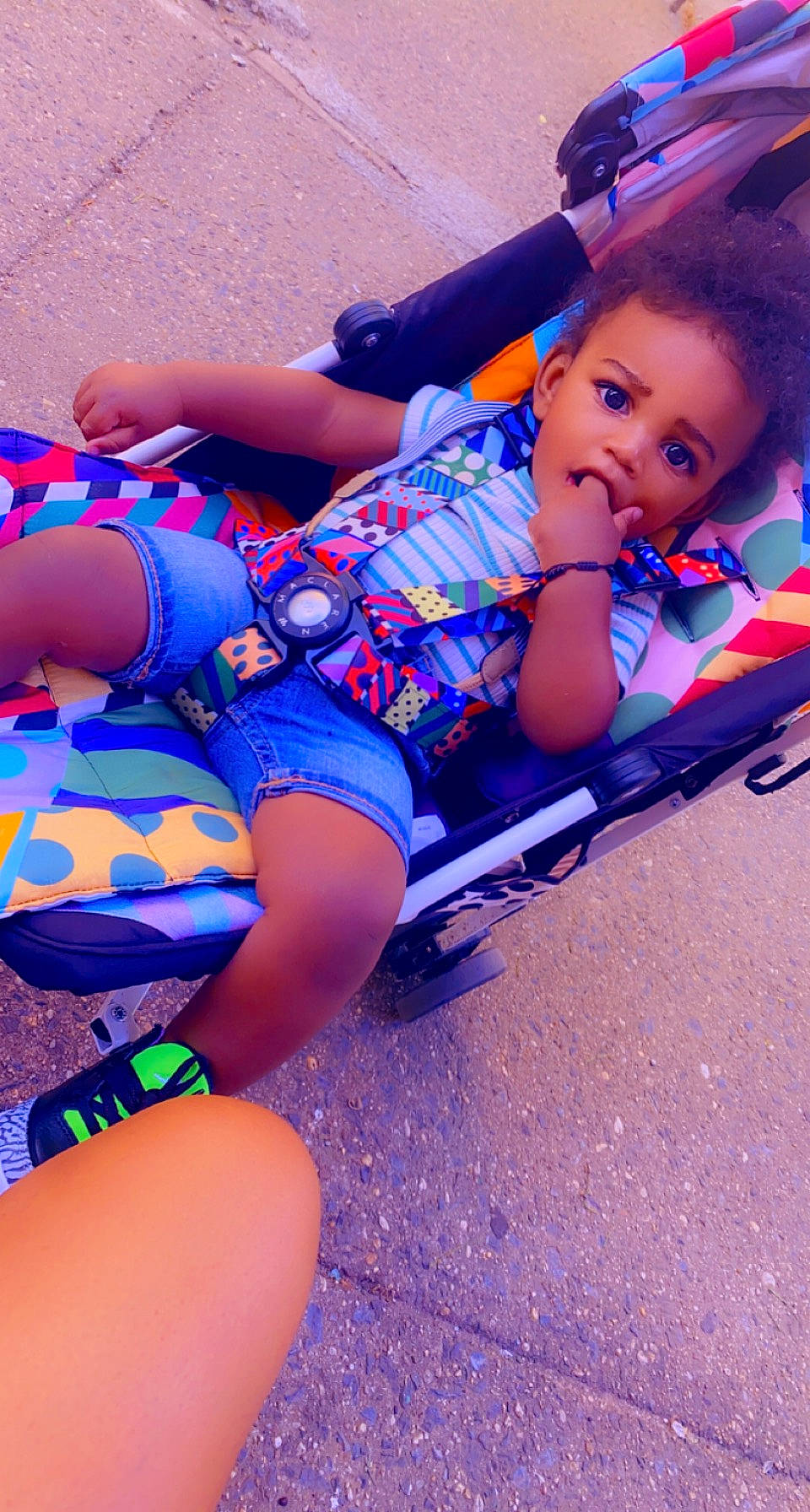 Noel is registered to the contest to win money with this photo: arm, automotive_design, automotive_tire, bumper, electric_blue, fun, grass, happy, human_body, human_leg, knee, leg, leisure, person, recreation, shorts, sitting, sneakers, surprise, thigh