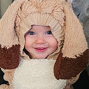 Essmae Lola-Rae joined the competition — help win amazing prizes! baby, child, costume, dog_costume, smiling, cute, fluffy, face, blue_eyes, infant, portrait, happy, indoors, warm, soft_texture, clothing, person, headwear, baby_fashion, adorable