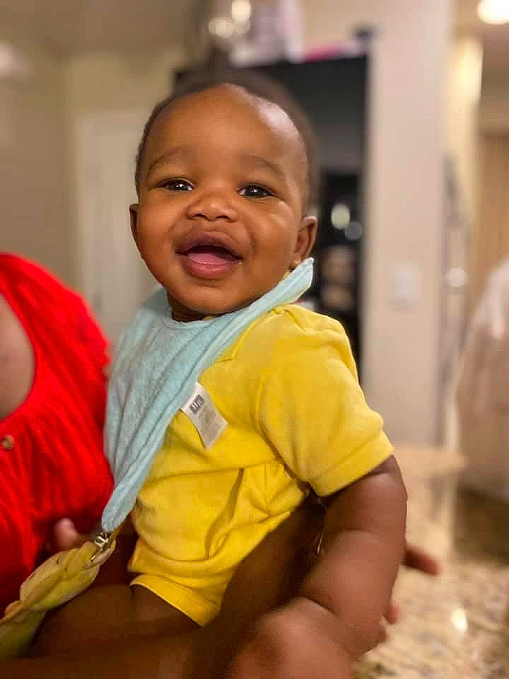 Khyel Daniel Franklin is registered to the contest to win money with this photo: abdomen, baby, baby_toddler_clothing, chair, cheek, child, comfort, flooring, fun, happy, person, room, sitting, skin, smile, t_shirt, thumb, toddler, vacation