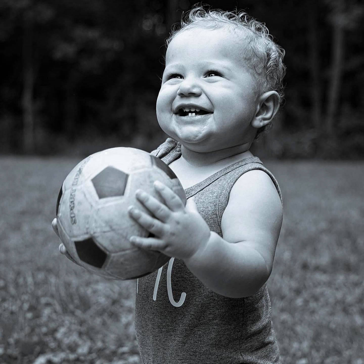 Oliver is registered to the contest to win money with this photo: arm, black, black_and_white, flash_photography, football, gesture, grass, hand, happy, human, joy, mammal, people_in_nature, person, playing_sports, smile, soccer, sports_equipment, standing, style