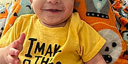 Roman joined the competition — help win amazing prizes! baby, smiling, yellow_shirt, blanket, diaper, face, child, toy, cat, indoor, happy, cute, infant, sitting, colorful, expression, playful, home, cozy, portrait