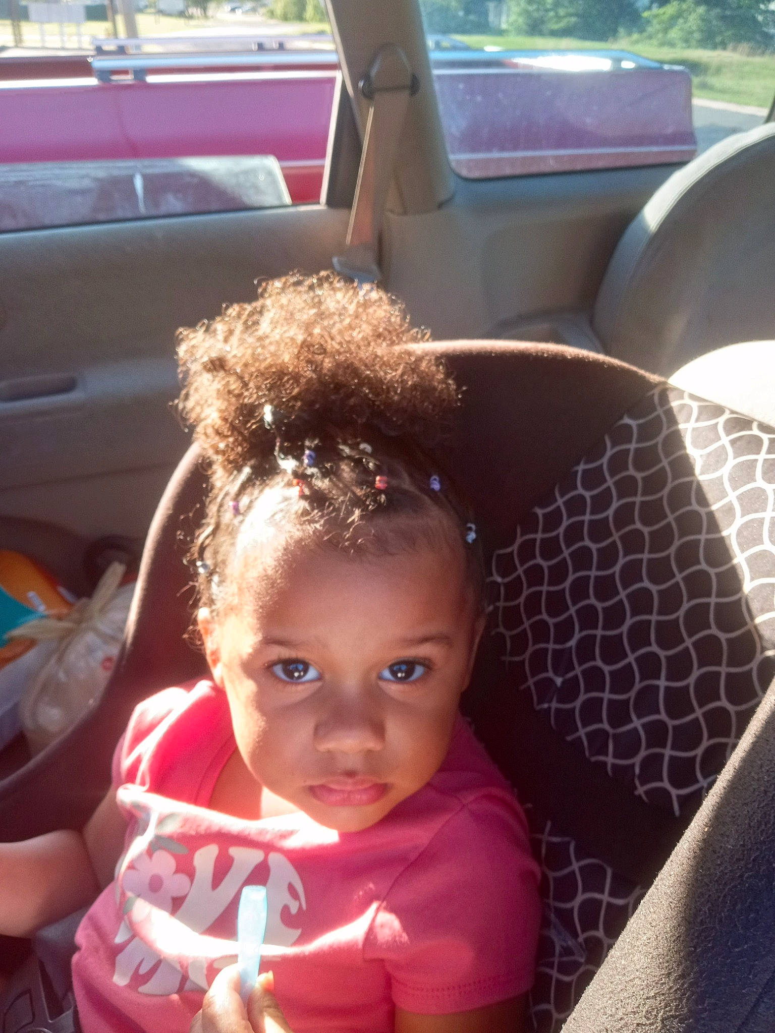 Londyn is registered to the contest to win money with this photo: auto_part, automotive_design, automotive_exterior, baby_toddler_clothing, car, car_seat, car_seat_cover, child, family_car, fun, happy, head, head_restraint, luxury_vehicle, motor_vehicle, person, sitting, steering_wheel, toddler, vehicle