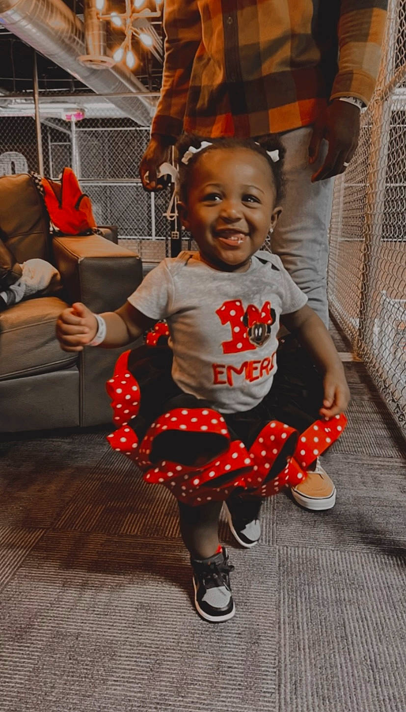 Emerie joined the competition — help win amazing prizes! baby, baby_toddler_clothing, child, costume, dance, event, fashion_design, flooring, fun, happy, joy, orange, pattern, people, performing_arts, person, sandal, sitting, smile, toddler