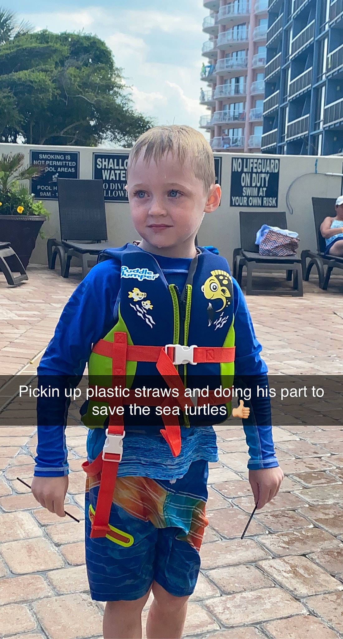 Brennan is registered to the contest to win money with this photo: blue, chair, child, city, costume, electric_blue, fictional_character, happy, leisure, person, personal_protective_equipment, recreation, sky, sleeve, sportswear, street_fashion, t_shirt, toddler, travel, tree