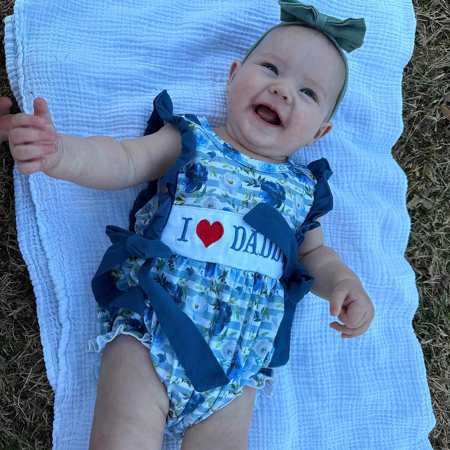 Brooklyn joined the competition — help win amazing prizes! baby, babylaughing, bodypart, clothing, dress, face, finger, grass, hand, happy, head, laughing, pants, person, photography, plant, portrait, quilt, shorts, smile