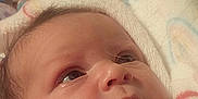 Addisyn joined the competition — help win amazing prizes! baby, infant, blanket, pink_clothing, face, hand, teddy_bear_pattern, closeup, curious, wide_eyes, newborn, soft_texture, pastel_colors, indoors, portrait, sleepwear, wrapped, cute, child, young
