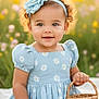 Camila is registered to the contest to win money with this photo: toddler, child, girl, blue_dress, flower_headband, basket, outdoor, wildflowers, sunlight, grass, smiling, curly_hair, sitting, blanket, nature, portrait, cute, happy, daylight, spring