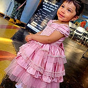 Mellodie-Grace joined the competition — help win amazing prizes! child, girl, pink_dress, indoor, floor, smiling, person, people, adult, sign, counter, lighting, casual, clothing, shoes, conversation, background, portrait, event, flooring