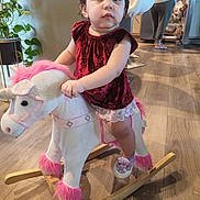 Mellodie-Grace joined the competition — help win amazing prizes! casual, child, curly_hair, footwear, fridge, furniture, home, indoor, kitchen, person, pink, plant, plush_toy, purple, rocking_horse, toddler, toy, unicorn, velvet_dress, wooden_floor