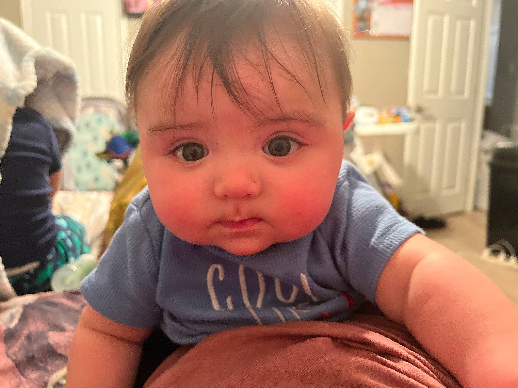 Elijah is registered to the contest to win money with this photo: baby, baby_toddler_clothing, cheek, child, ear, eyelash, finger, fun, happy, iris, lip, mouth, nose, person, room, sitting, skin, smile, t_shirt, thumb