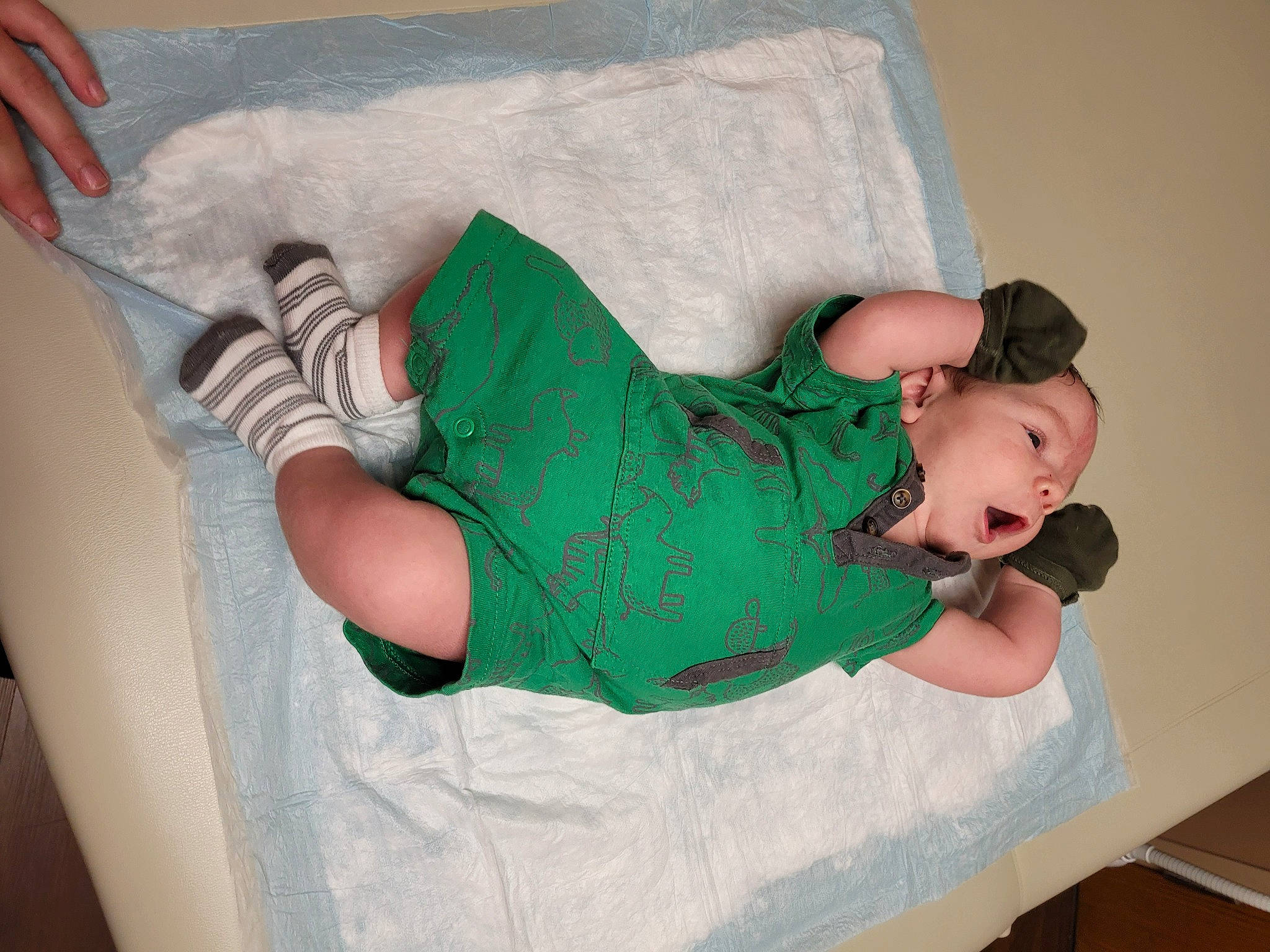Atticus James is registered to the contest to win money with this photo: baby_toddler_clothing, child, comfort, foot, hand, human_leg, joint, knee, lap, leg, linens, pattern, person, sandal, shoulder, sitting, sleeve, sock, textile, thigh