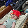 Maximus joined the competition — help win amazing prizes! baby, infant, child, graduation_cap, red_hat, cradle, crib, wooden_furniture, onesie, portrait, lying_down, indoors, living_room, blanket, couch, home, cat, cozy, face, safe