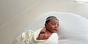 Leylani participe au concours pour gagner de l'argent avec cette photo : baby, blanket, comfort, cozy, curtain, cushion, headband, indoors, infant, minimalist, natural_light, newborn, peaceful, portrait, resting, sleeping, small_feet, soft, white, wrapped