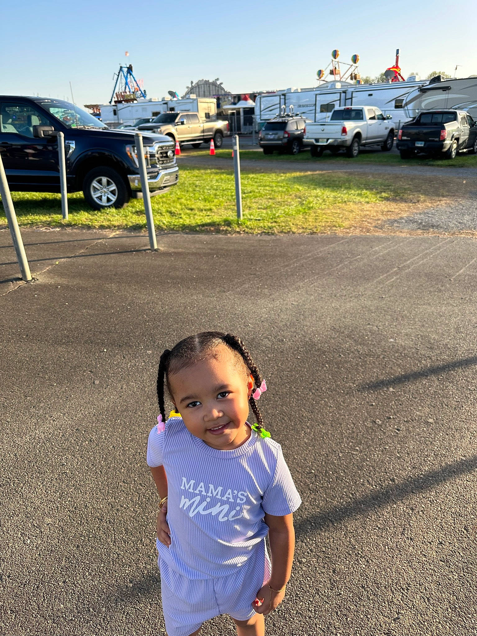 London is registered to the contest to win money with this photo: asphalt, automotive_tire, baby_toddler_clothing, car, grass, happy, joy, land_vehicle, leisure, morning, motor_vehicle, person, recreation, road, road_surface, sky, summer, tire, toddler, travel