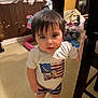 toddler, child, indoor, standing, shirt, shorts, boots, furniture, chair, floor, window, curious, person, hair, face, hand, expression, room, messy, toy