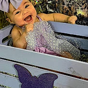 Adelina joined the competition — help win amazing prizes! baby, child, smiling, bow, lavender, dress, crate, purple, butterfly, happy, face, portrait, polka_dot, sitting, infant, cute, decor, background, person, joyful