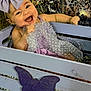 baby, child, smiling, bow, lavender, dress, crate, purple, butterfly, happy, face, portrait, polka_dot, sitting, infant, cute, decor, background, person, joyful