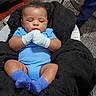 baby, infant, sleeping, portrait, blue_outfit, mittens, socks, plush_chair, seated, indoors, cozy, face, closed_eyes, dark_hair, smiling, household, fan, carpet, wood_floor, photography