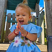 Elsa Stefania joined the competition — help win amazing prizes! toddler, child, smiling, clapping, blue_dress, flower_embroidery, outdoor, playground, wooden_structure, happy, cute, sunny, daylight, earrings, blonde_hair, casual, nature, fun, joy, portrait