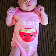 Raven is registered to the contest to win money with this photo: baby, infant, onesie, pink_clothing, miso_soup_graphic, lying_down, striped_surface, cute_expression, socks, small_fists, child, portrait, indoors, soft_lighting, looking_up, adorable, casual, comfortable, person, young_child