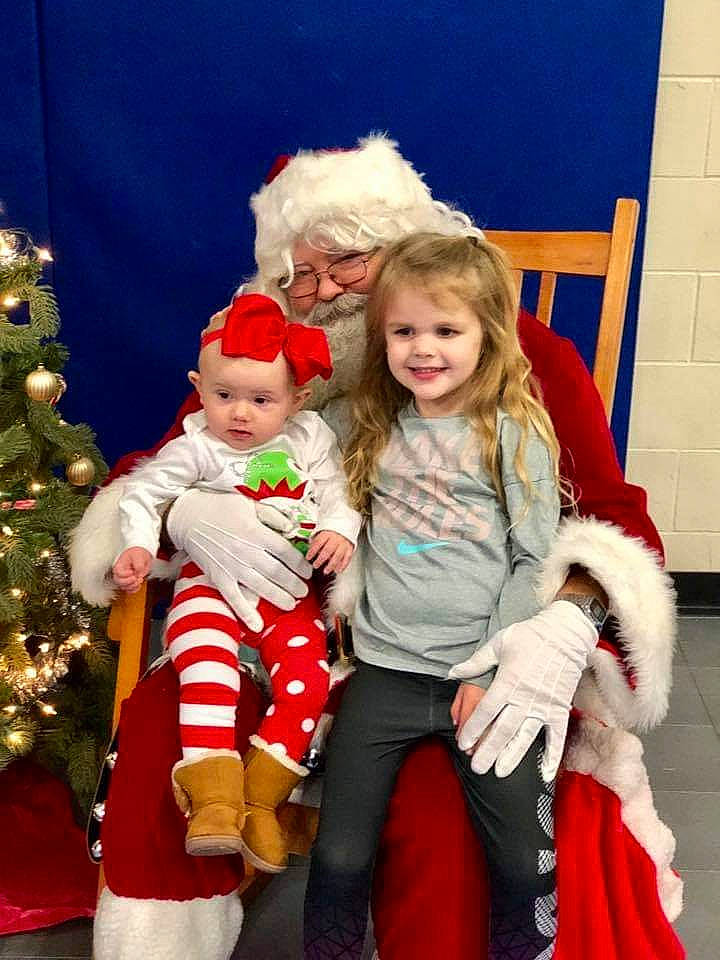 Blakeleigh is registered to the contest to win money with this photo: child, christmas, christmas_decoration, christmas_eve, christmas_ornament, christmas_tree, event, fictional_character, fur, holiday, human_body, joy, lap, person, santa_claus, smile, toddler