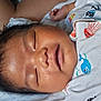 Kieran is registered to the contest to win money with this photo: baby, sleeping, infant, face, hair, onesie, clothing, blanket, closeup, peaceful, resting, skin, child, cute, young, portrait, indoors, soft, relaxed, toddler