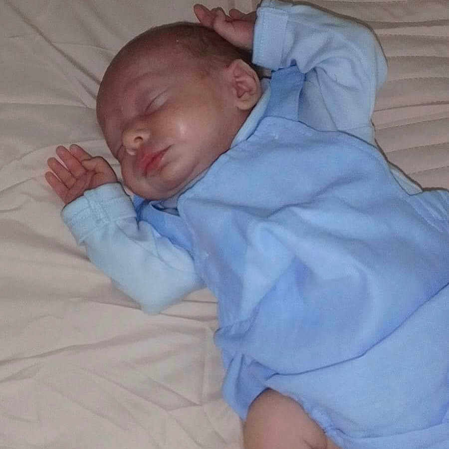 Kruize is registered to the contest to win money with this photo: baby, bed, bedroom, blanket, clothing, cushion, face, furniture, head, homedecor, hosiery, indoors, newborn, pants, person, photography, portrait, room, sleeping, sock