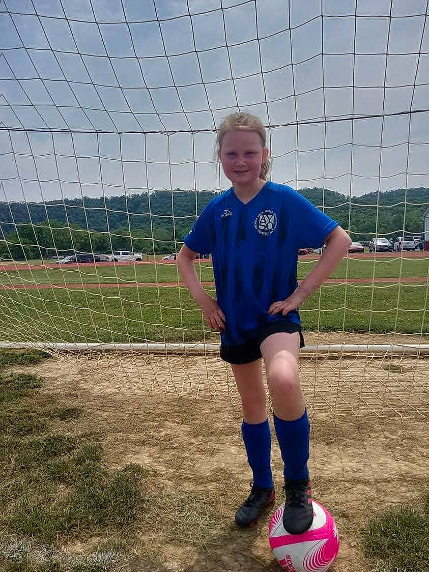 Tatianna joined the competition — help win amazing prizes! ball, ball_game, competition_event, fence, football, footwear, grass, joy, knee, leg, mesh, person, player, shoe, shorts, sky, smile, sneakers, soccer, sock