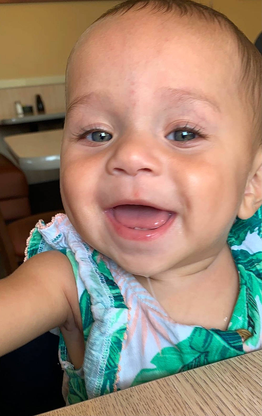 Amaya is registered to the contest to win money with this photo: baby, baby_toddler_clothing, chair, cheek, child, ear, eyebrow, eyelash, finger, fun, happy, iris, lip, mouth, nose, person, skin, smile, table, toddler