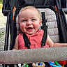 Stetson joined the competition — help win amazing prizes! baby, child, smiling, stroller, toy, outdoor, pink_clothing, happy, face, infant, seatbelt, cute, play, person, head, cheerful, daylight, expression, cute_outfit, safety_harness