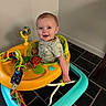 baby, child, walker, toy, smile, happy, indoor, floor, tiles, clothing, person, infant, bright, play, seat, plastic, colorful, face, cute, young