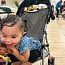 Nova joined the competition — help win amazing prizes! child, toddler, stroller, smiling, happy, portrait, indoor, food_court, restaurant, seated, blue_shirt, striped_clothing, wet_hair, playful, face, person, wheelchair_like_stroller, tile_floor, background_people, everyday_life
