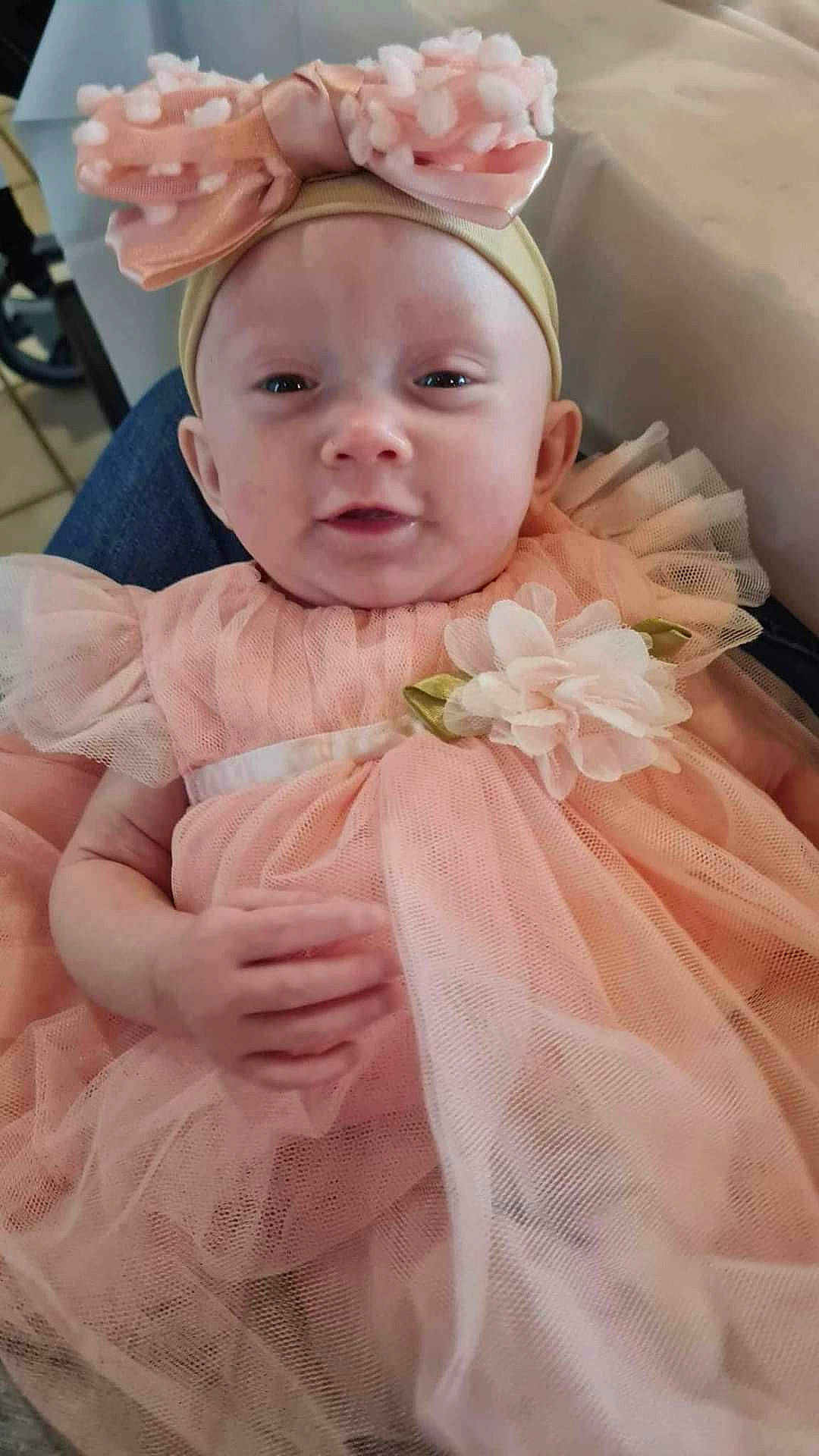 Lorna joined the competition — help win amazing prizes! baby, baby_toddler_clothing, bridal_accessory, bridal_clothing, chair, child, dress, event, eye, happy, headgear, headpiece, headwear, iris, jewellery, peach, person, petal, pink, skin