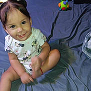 Luna joined the competition — help win amazing prizes! toddler, child, smiling, bed, toy, onesie, minnie_mouse, indoor, person, face, happy, clothing, furniture, blanket, head, sitting, playful, cute, infant, baby
