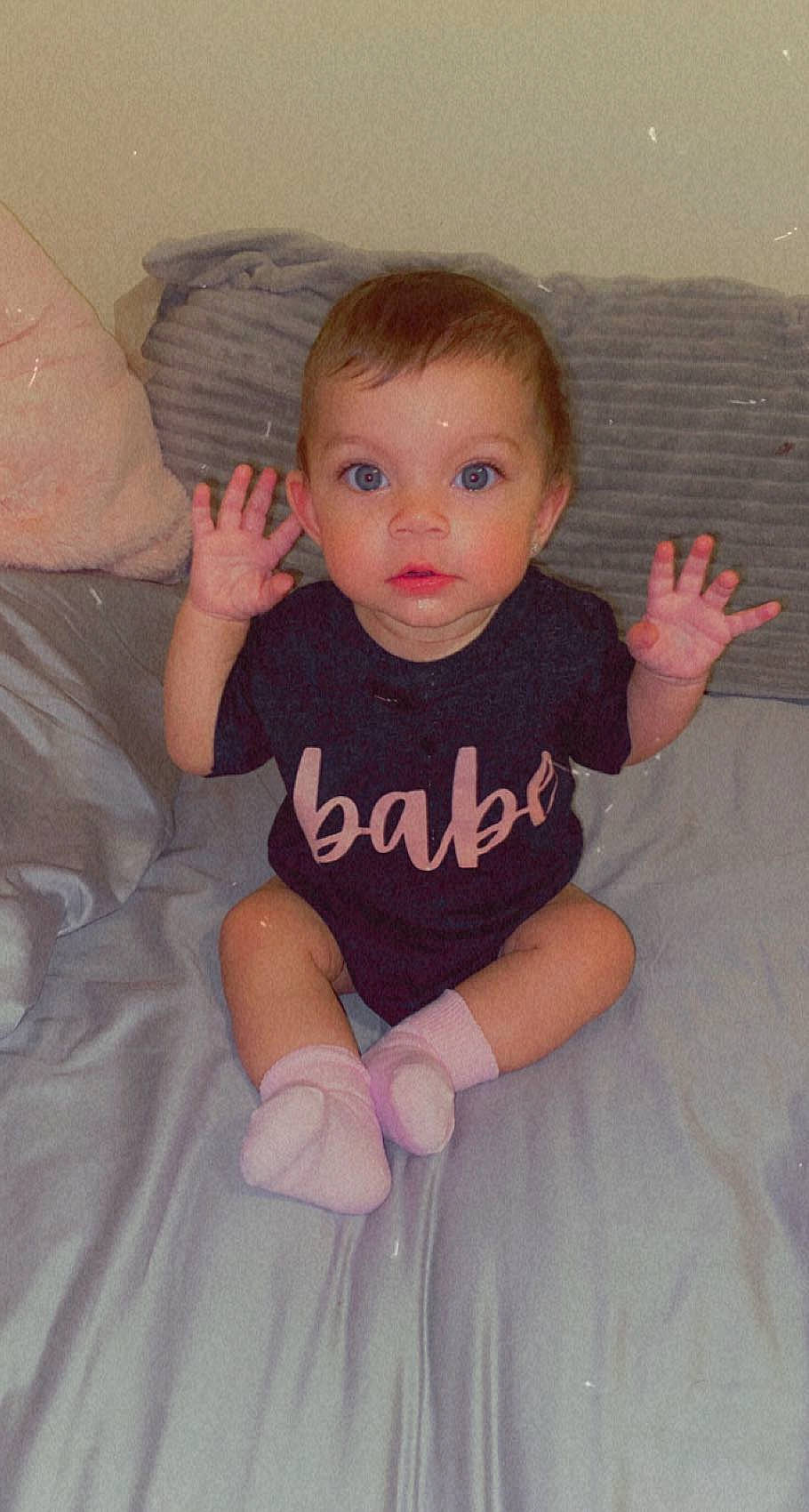 Penny is registered to the contest to win money with this photo: arm, baby_toddler_clothing, cheek, chin, eye, face, facial_expression, hair, hand, head, human_body, joint, leg, lip, muscle, neck, nose, organ, person, shoulder