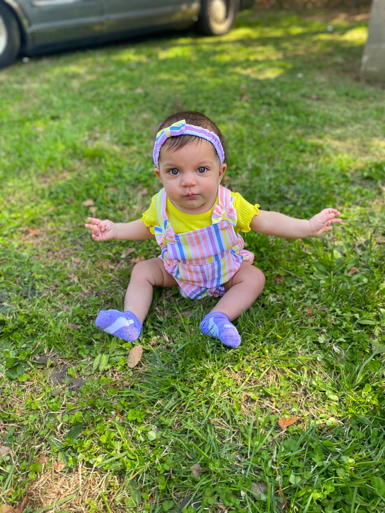 Penny is registered to the contest to win money with this photo: automotive_tire, baby_toddler_clothing, electric_blue, grass, grass_family, grassland, groundcover, happy, hat, headwear, lawn, leisure, meadow, people_in_nature, person, plant, summer, tire, toddler, vehicle_door