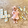 Beya participe au concours pour gagner de l'argent avec cette photo : baby, infant, pink_clothing, robe, slippers, diapers, baby_care_products, lotion, cream, brush, soft_carpet, lying_down, indoors, cute, child, skincare, baby_bath, calm, toddler, headwrap