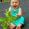 toddler, child, smiling, happy, sitting, dress, barefoot, leafy_branch, trampoline, outdoor, greenery, nature, grass, playful, summer, young_child, expression, joy, person, casual
