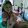 Chevelle Steptoe joined the competition — help win amazing prizes! child, baby, bedroom, girl, holding, sleeping, pajamas, bottle, blanket, furniture, television, laundry_basket, bed, quilt, indoor, person, family, home, smiling, cozy