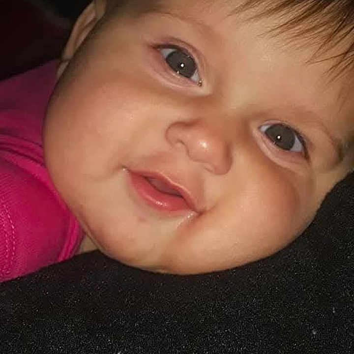 Nova joined the competition — help win amazing prizes! baby, child, face, smiling, close_up, pink_clothing, resting, portrait, indoor, young_child, cute, chubby_cheeks, big_eyes, infant, happy, head, skin, human, person, social_media_interface