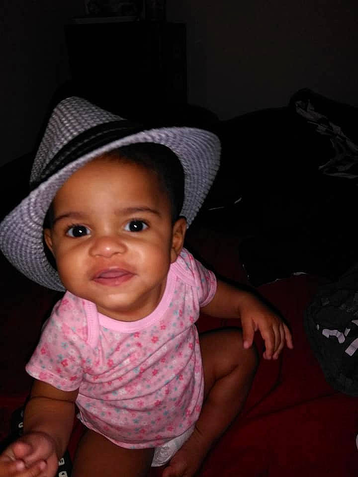 Annalee is registered to the contest to win money with this photo: black_hair, cheek, child, cool, eye, fashion_accessory, finger, fun, girl, hand, hat, head, headgear, infant, person, pink, product, sitting, skin, smile