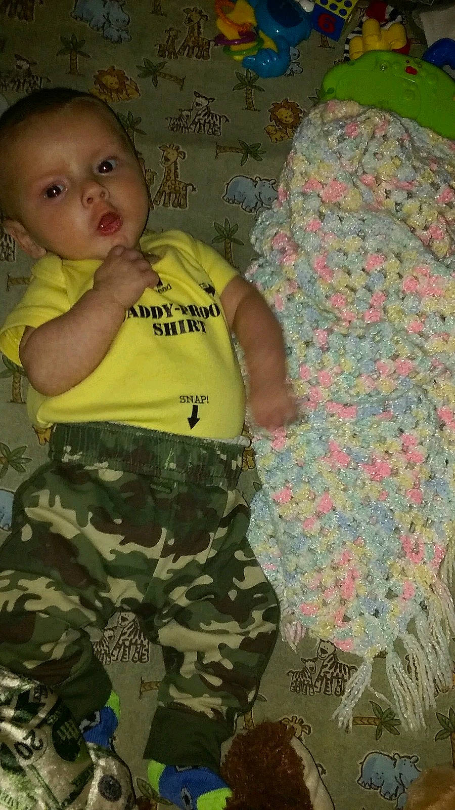 Charlie is registered to the contest to win money with this photo: baby, baby_toddler_clothing, camouflage, child, comfort, design, fun, leaf, linens, military_camouflage, military_person, military_uniform, pattern, person, room, sleeve, soldier, t_shirt, textile, toddler