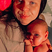 Joshua Corey is registered to the contest to win money with this photo: woman, baby, infant, face, skin, hand, lying_down, close_up, bonding, parent, child, portrait, skin_tone, expression, indoor, cuddle, love, family, comfort, relaxation