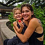 Murphy joined the competition — help win amazing prizes! child, woman, smiling, hug, lollipop, tattoo, outdoor, bench, greenery, tree, curved_bench, casual_clothing, happy, nature, portrait, family, bonding, daylight, plant, urban_park