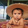 toddler, child, hat, beach, pier, sand, necklace, blanket, sunhat, outdoor, water, ocean, sky, clouds, person, summer, vacation, cute, portrait, curious