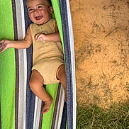 Fox joined the competition — help win amazing prizes! baby, smiling, hammock, striped, outdoor, grass, dirt, infant, happy, relaxed, clothing, cute, child, person, nature, sunlight, skin, one_person, portrait, leisure
