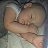 arm, baby, bedding, blanket, cheek, closeup, crib, eyelid, face, flash_photography, foot, indoor, infant, nighttime, onesie, peaceful, pillow, portrait, sleeping, stuffed_animal
