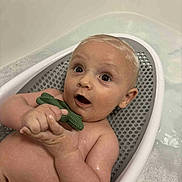 Archie is registered to the contest to win money with this photo: baby, bath, bathtub, child, cute, face, foam, fun, happy, infant, inside, kid, person, plastic, play, portrait, seat, soap, teether, water
