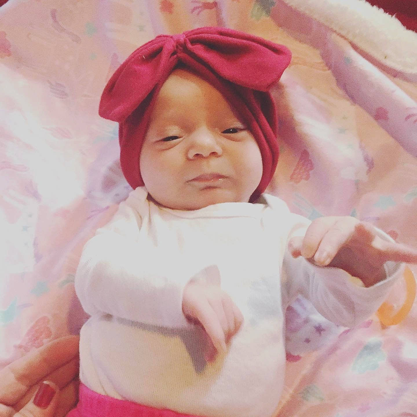 Alaiya is registered to the contest to win money with this photo: baby, cheek, child, headgear, headwear, person, pink, portrait, smile, toddler